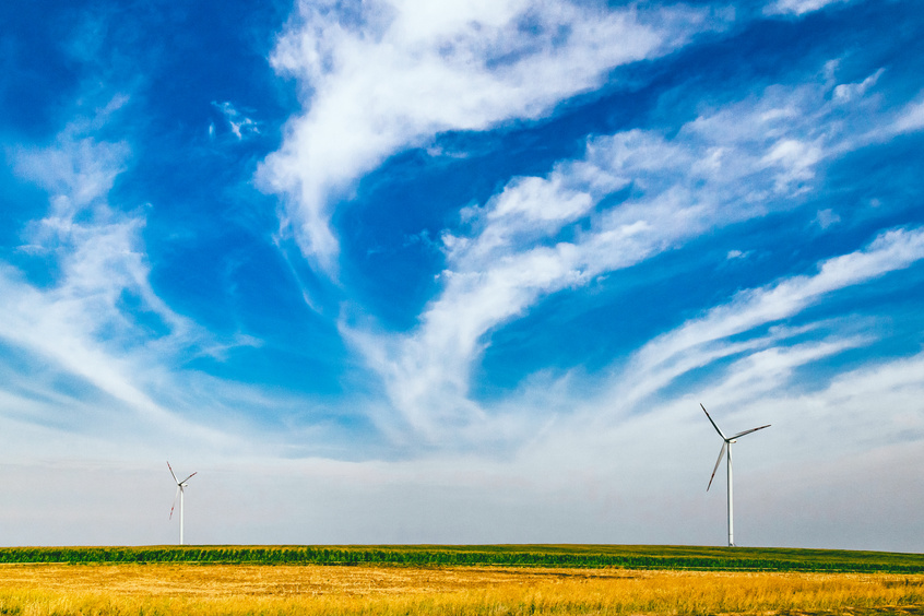 Two Wind Turbines Under Blue Sky